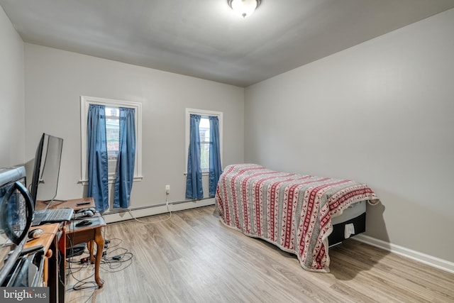 303 Lincoln Ave, Bristol, PA 19007 - bedroom featuring a baseboard radiator and light wood-style flooring
