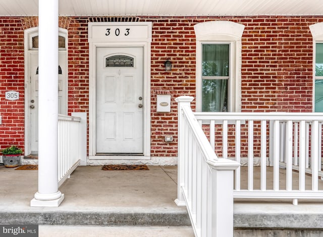 303 Lincoln Ave, Bristol, PA 19007 - property entrance featuring brick siding and a porch