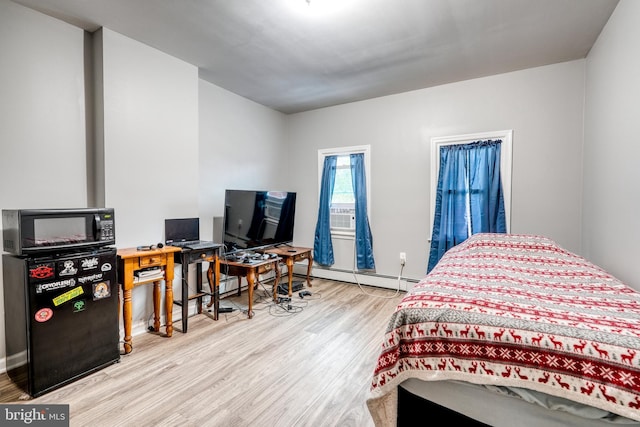 303 Lincoln Ave, Bristol, PA 19007 - bedroom with wood finished floors, a baseboard heating unit, and a desk