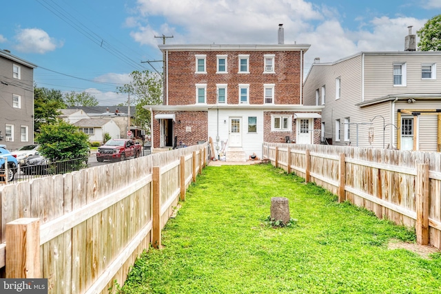303 Lincoln Ave, Bristol, PA 19007 - back of property featuring entry steps, a fenced backyard, and brick siding
