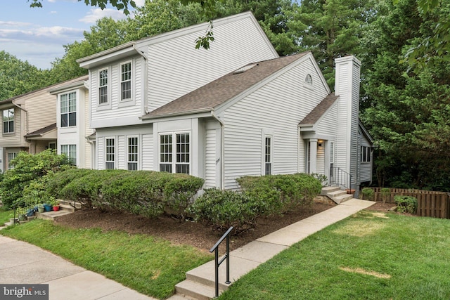 1544 Ingram Ter, Silver Spring, MD 20906 - view of front facade with roof with shingles, a front lawn, and a chimney