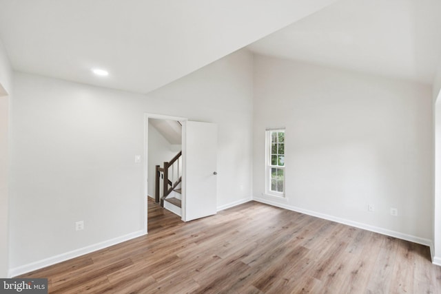 1544 Ingram Ter, Silver Spring, MD 20906 - unfurnished room featuring stairway, wood finished floors, vaulted ceiling, and recessed lighting