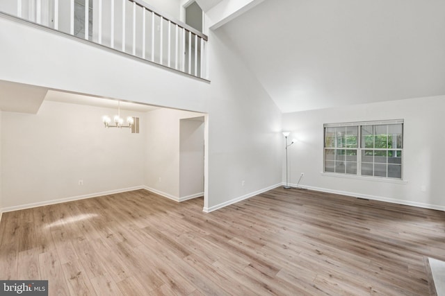 1544 Ingram Ter, Silver Spring, MD 20906 - unfurnished living room featuring high vaulted ceiling, a chandelier, and wood finished floors