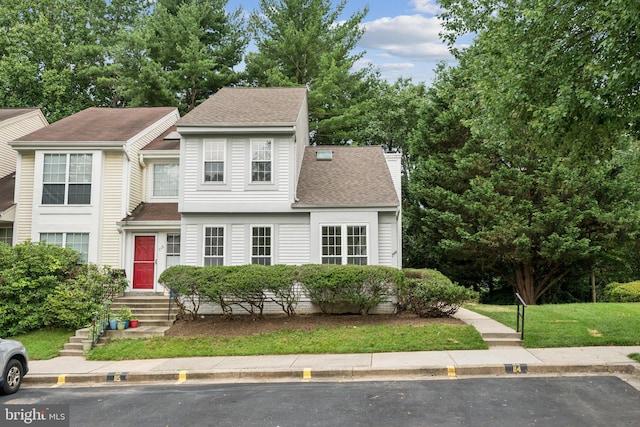 1544 Ingram Ter, Silver Spring, MD 20906 - view of front of house with a shingled roof, a chimney, and a front lawn