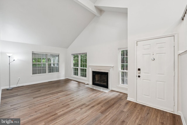 1544 Ingram Ter, Silver Spring, MD 20906 - unfurnished living room featuring high vaulted ceiling, beam ceiling, wood finished floors, and a high end fireplace