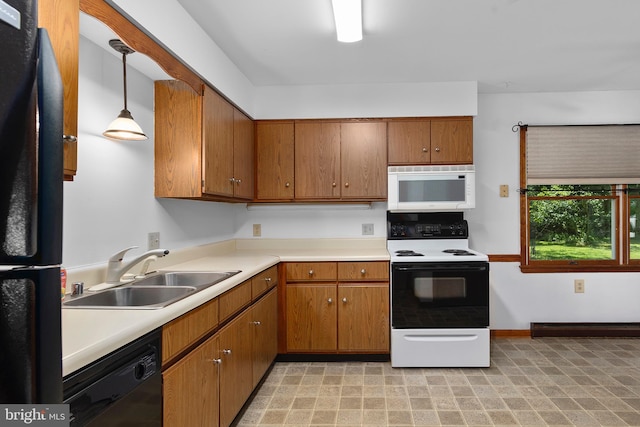 10624 Millbrook Dr, Chestertown, MD 21620 - kitchen with black appliances, brown cabinetry, light countertops, and hanging light fixtures