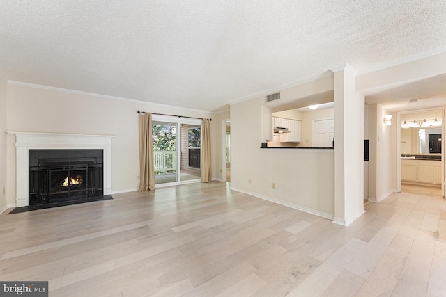 1517 Lincoln Way Unit 204, Mclean, VA 22102 - unfurnished living room featuring a textured ceiling, a fireplace with flush hearth, light wood finished floors, and ornamental molding