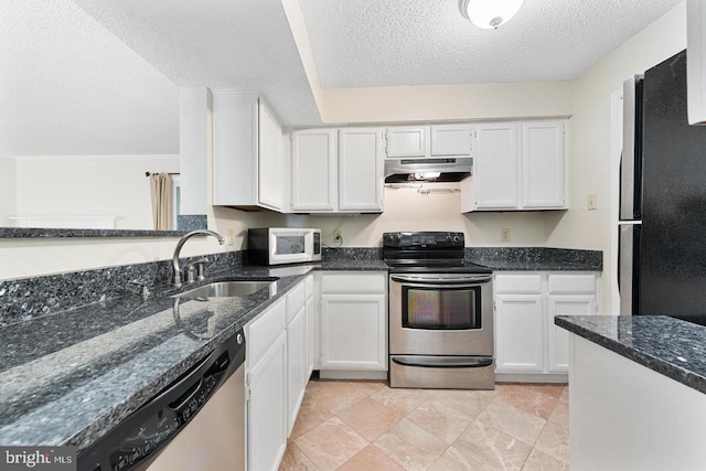 1517 Lincoln Way Unit 204, Mclean, VA 22102 - kitchen with appliances with stainless steel finishes, extractor fan, a textured ceiling, white cabinetry, and dark stone countertops