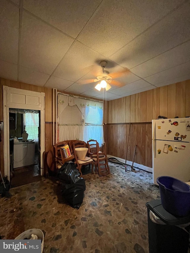 2524 Mchenry St, Baltimore, MD 21223 - living area with ceiling fan, a drop ceiling, wood walls, and washer / clothes dryer