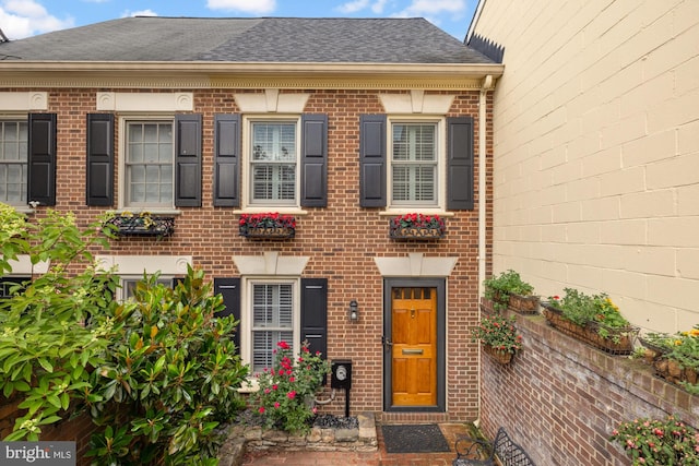 624 S Pitt St Unit 1/2, Alexandria, VA 22314 - view of front facade with brick siding and a shingled roof