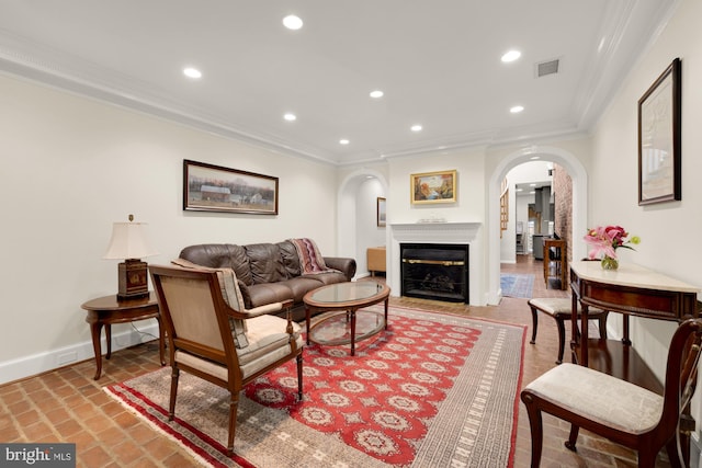 624 S Pitt St Unit 1/2, Alexandria, VA 22314 - living room with arched walkways, ornamental molding, recessed lighting, a glass covered fireplace, and brick flooring