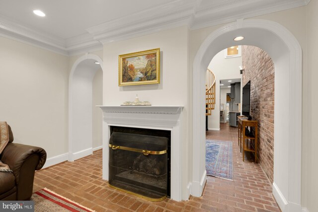 624 S Pitt St Unit 1/2, Alexandria, VA 22314 - living area featuring brick flooring, a fireplace, arched walkways, brick wall, and ornamental molding
