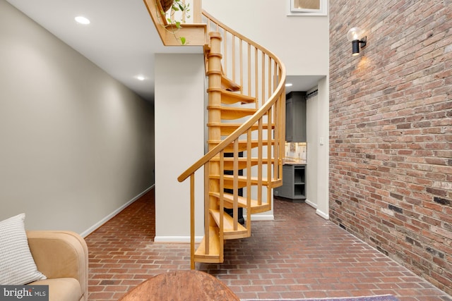 624 S Pitt St Unit 1/2, Alexandria, VA 22314 - stairway with brick floors, brick wall, and recessed lighting
