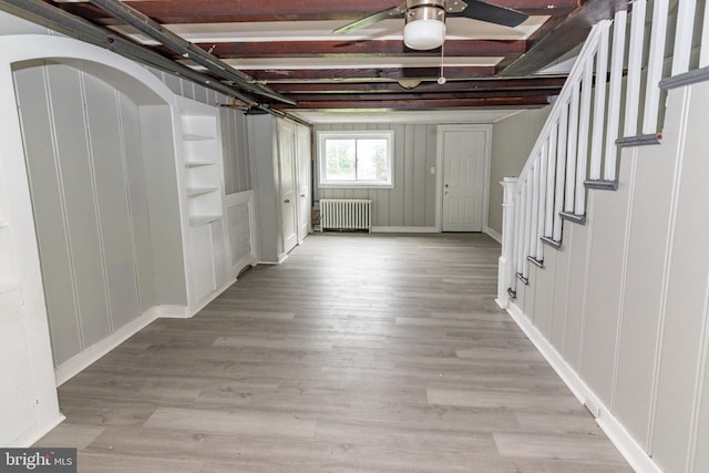 3116 Presstman St, Baltimore, MD 21216 - basement featuring radiator, stairway, ceiling fan, and light wood-type flooring