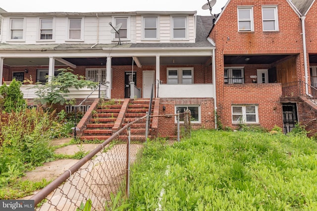 3116 Presstman St, Baltimore, MD 21216 - townhome / multi-family property featuring brick siding, stairway, and roof with shingles