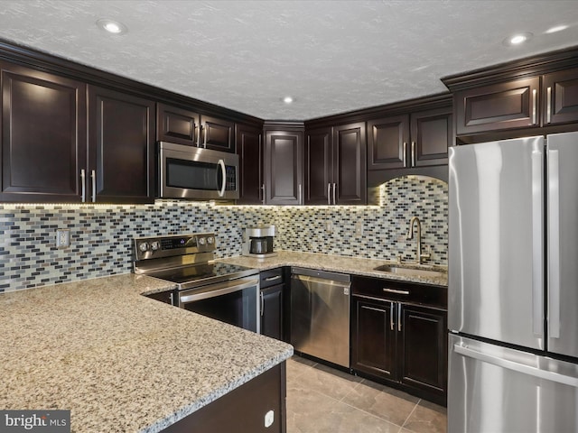 7313 Husky Ln, Springfield, VA 22151 - kitchen featuring appliances with stainless steel finishes, light stone counters, tasteful backsplash, and recessed lighting
