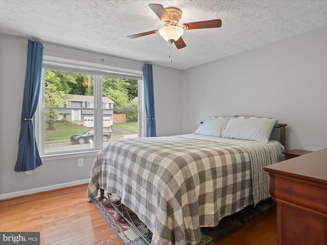 7313 Husky Ln, Springfield, VA 22151 - bedroom featuring wood finished floors, a textured ceiling, and ceiling fan