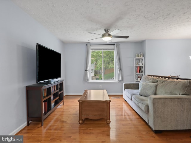 7313 Husky Ln, Springfield, VA 22151 - living area featuring a ceiling fan, a textured ceiling, and light wood finished floors
