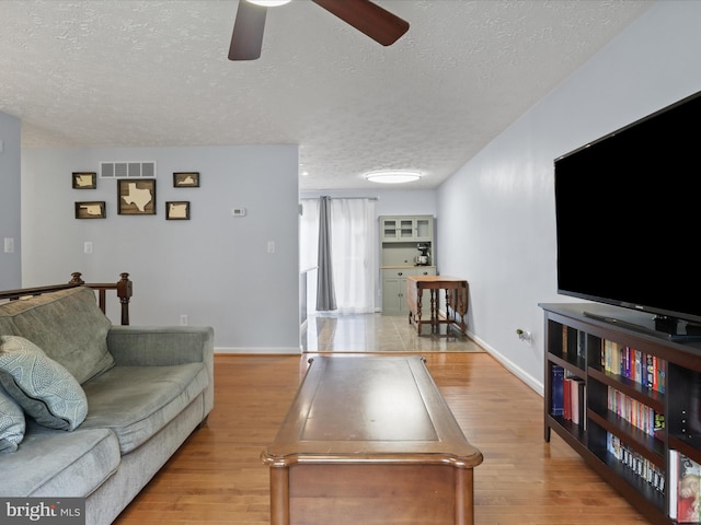 7313 Husky Ln, Springfield, VA 22151 - living room with a ceiling fan, a textured ceiling, and wood finished floors