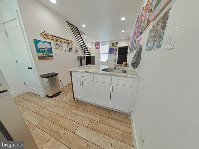 2230 N Mutter St, Philadelphia, PA 19133 - kitchen featuring white cabinetry, recessed lighting, light stone countertops, wood finish floors, and a peninsula