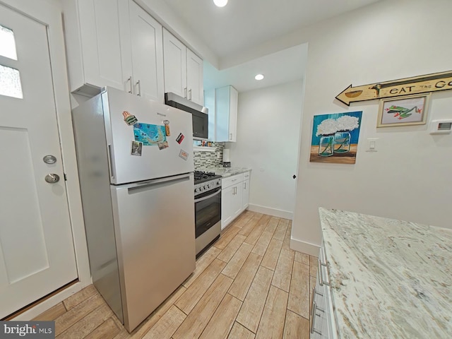 2230 N Mutter St, Philadelphia, PA 19133 - kitchen featuring appliances with stainless steel finishes, light wood finished floors, white cabinets, recessed lighting, and light stone counters