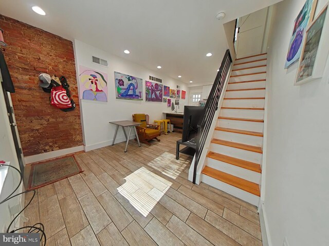 2230 N Mutter St, Philadelphia, PA 19133 - foyer featuring stairs, light wood-type flooring, recessed lighting, and brick wall