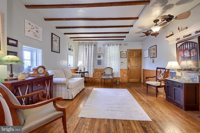48 Ranck Ave, Lancaster, PA 17602 - living room featuring light wood-style floors, a wainscoted wall, beamed ceiling, and a ceiling fan