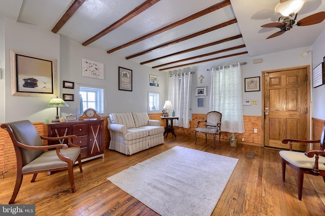 48 Ranck Ave, Lancaster, PA 17602 - living room with beamed ceiling, wood-type flooring, a ceiling fan, and a wainscoted wall