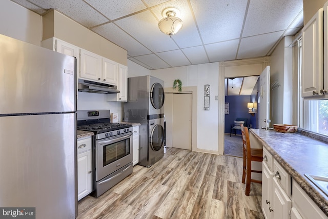 48 Ranck Ave, Lancaster, PA 17602 - kitchen featuring stainless steel appliances, a drop ceiling, under cabinet range hood, stacked washer / drying machine, and light wood-style floors