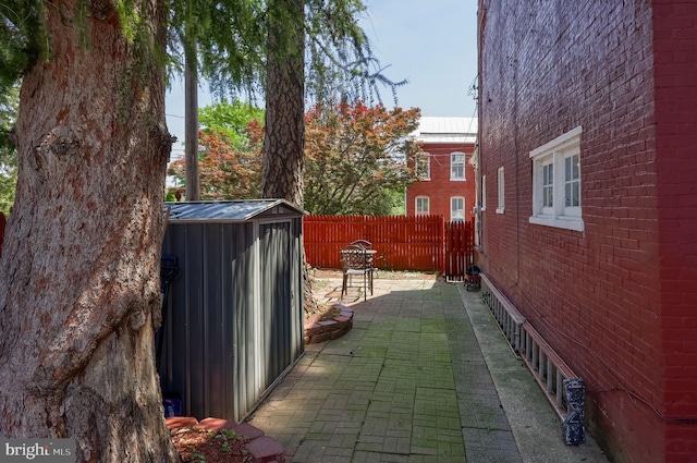 48 Ranck Ave, Lancaster, PA 17602 - view of property exterior with a patio, a storage unit, a fenced backyard, and brick siding