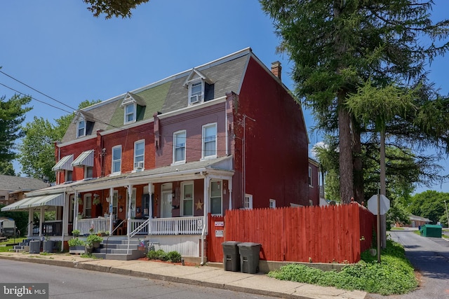 48 Ranck Ave, Lancaster, PA 17602 - view of property featuring a porch, a chimney, and brick siding