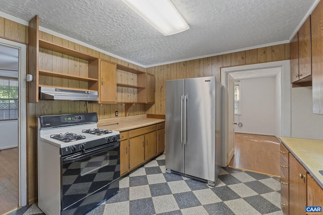 1562 Thomas Jefferson Pkwy, Charlottesville, VA 22901 - kitchen with white gas range oven, high quality fridge, under cabinet range hood, wooden walls, and light countertops