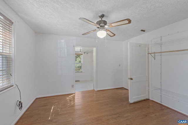 1562 Thomas Jefferson Pkwy, Charlottesville, VA 22901 - unfurnished bedroom with a textured ceiling, wood finished floors, a closet, and ceiling fan