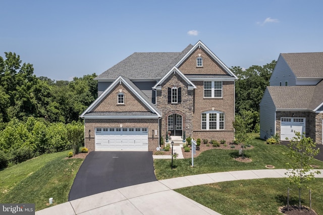 5745 Hawk Ridge Rd, Frederick, MD 21704 - view of front of property featuring brick siding, driveway, a garage, and a front yard