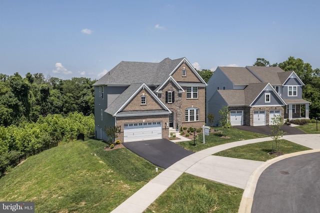 5745 Hawk Ridge Rd, Frederick, MD 21704 - view of front of home featuring driveway, a front lawn, a garage, and brick siding