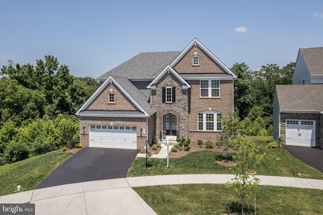 5745 Hawk Ridge Rd, Frederick, MD 21704 - view of front of home with brick siding, asphalt driveway, and a front yard