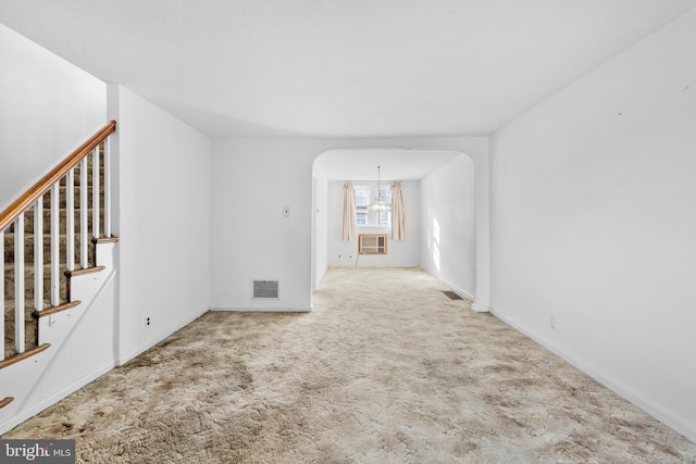 6344 Glenloch St, Philadelphia, PA 19135 - empty room featuring carpet floors, arched walkways, stairs, a chandelier, and cooling unit
