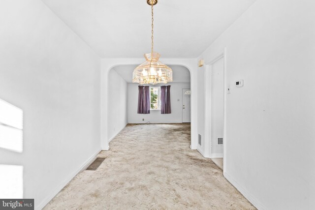 6344 Glenloch St, Philadelphia, PA 19135 - unfurnished dining area featuring arched walkways, a chandelier, and carpet flooring