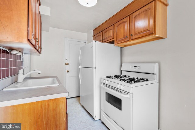6344 Glenloch St, Philadelphia, PA 19135 - kitchen with white appliances, brown cabinetry, and light countertops
