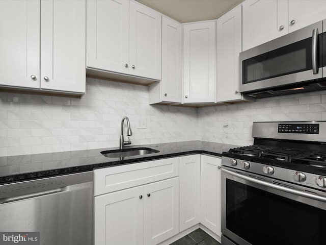 18615 Walkers Choice Rd # 2, Gaithersburg, MD 20886 - kitchen featuring stainless steel appliances, white cabinets, backsplash, and dark stone countertops