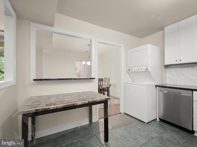 18615 Walkers Choice Rd # 2, Gaithersburg, MD 20886 - laundry room featuring stacked washer / drying machine and dark tile patterned flooring