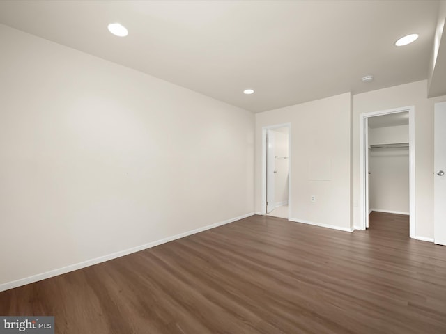 18615 Walkers Choice Rd # 2, Gaithersburg, MD 20886 - unfurnished bedroom with dark wood finished floors, a walk in closet, recessed lighting, and a closet