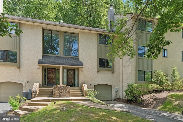 500 Lynetree Dr Unit 1-C, West Chester, PA 19380 - view of front of home with a garage, stucco siding, and driveway