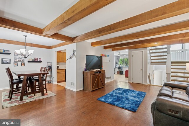 500 Lynetree Dr Unit 1-C, West Chester, PA 19380 - living room featuring a chandelier, wood finished floors, and beam ceiling