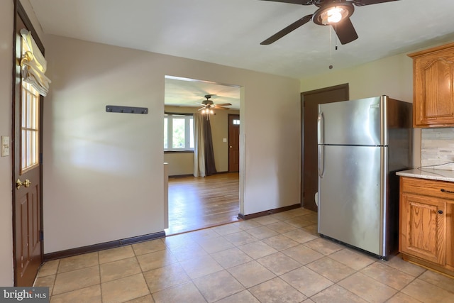 101 Walton Ave, Carlisle, PA 17013 - kitchen featuring freestanding refrigerator, ceiling fan, light countertops, brown cabinetry, and light tile patterned floors