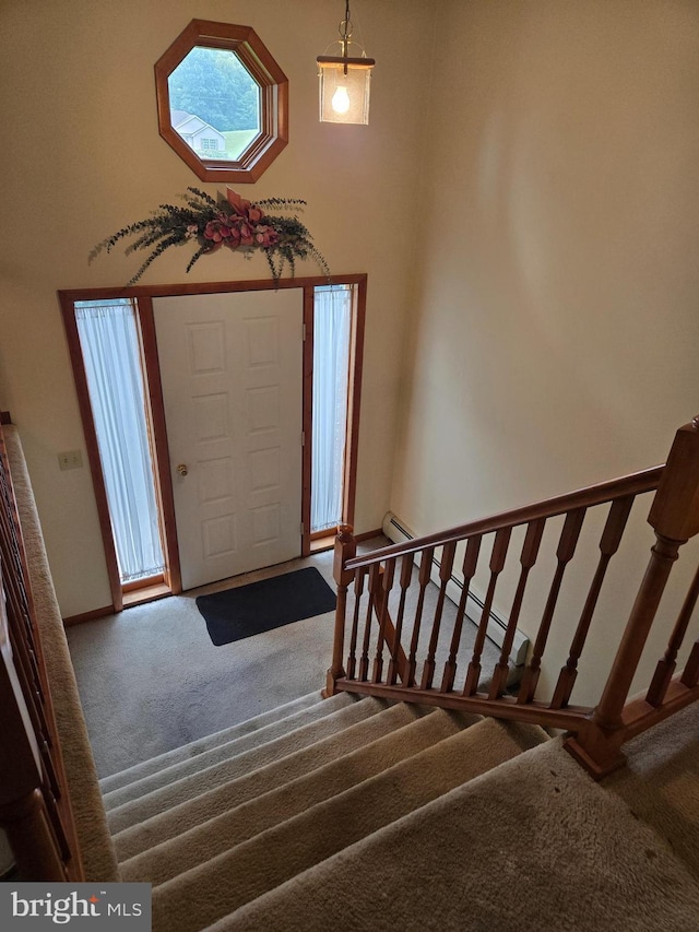 526 Fairground Rd, Newport, PA 17074 - carpeted entryway with stairs, a towering ceiling, and baseboard heating