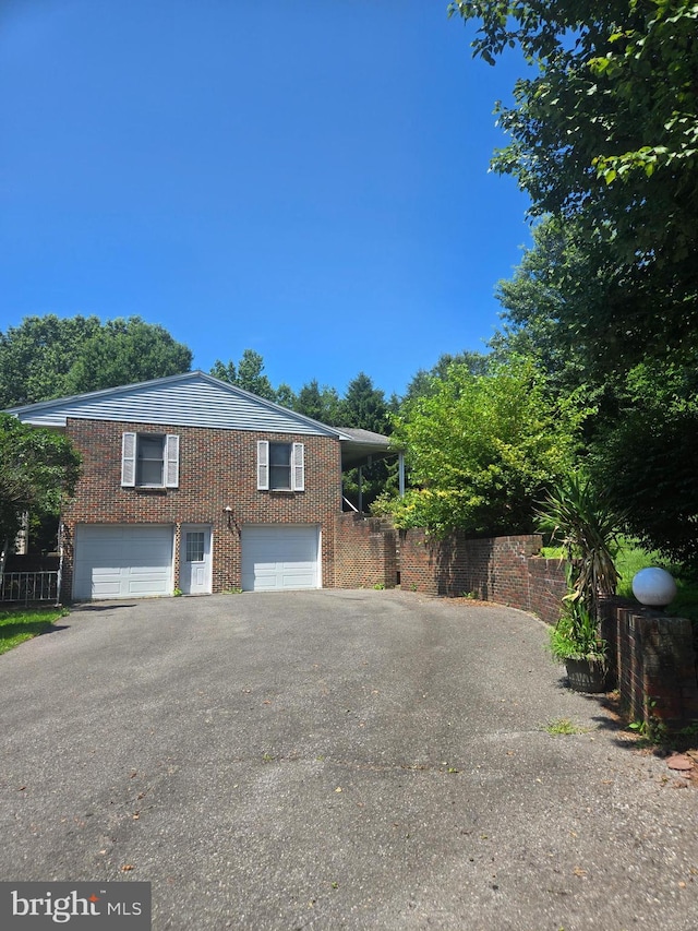 526 Fairground Rd, Newport, PA 17074 - view of side of property featuring driveway, a garage, and brick siding