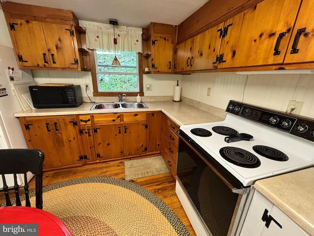 4677 Back Hollow Rd, Blain, PA 17006 - kitchen featuring white range with electric stovetop, black microwave, light countertops, and brown cabinetry