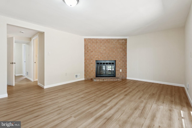 10779 Cordage Walk, Columbia, MD 21044 - unfurnished living room featuring light wood finished floors and a brick fireplace