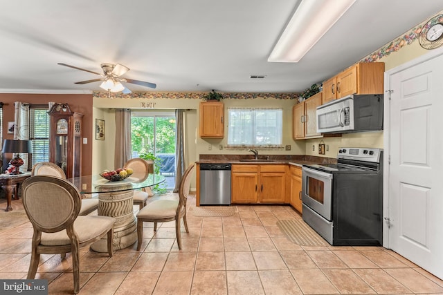8910 Edison Ln, Clinton, MD 20735 - kitchen featuring appliances with stainless steel finishes, dark countertops, light tile patterned floors, and ceiling fan